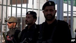 Pakistani security personal stand guard at the entrance of the National Assembly building during an assembly session in Islamabad, Pakistan, Tuesday, Jan. 6, 2015.