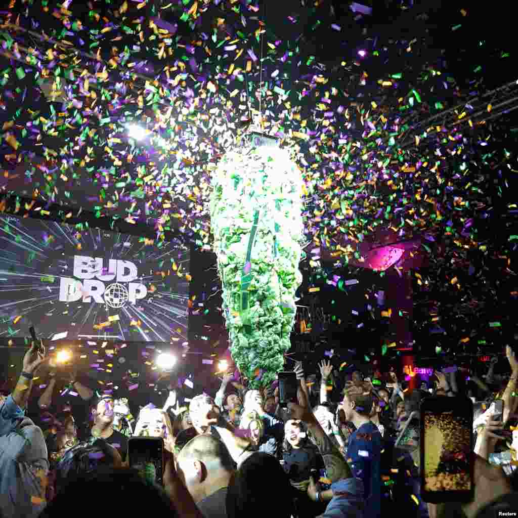 A decoration resembling a giant marijuana bud drops into the crowd at midnight, during a party marking the legalization of recreational cannabis in Toronto, Ontario, Canada. (Credit: Chandra Raye/@chachmusic/Handout)