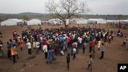 South Sudanese refugees at the Imvepi camp in Uganda gather under a tree. The civil war in South Sudan has killed tens of thousands and driven many thousands from their homes. (AP Photo/Jerome Delay) 