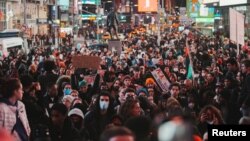 People take part in a protest following the release of a video showing police officers beating Tyre Nichols, in New York, Jan. 28, 2023.