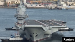 资料照：中国自制航母“山东舰”驶出大连港开始第九次海试（2019年11月14日）。