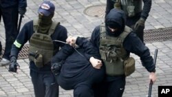 Police detain a man during an opposition rally to protest the official presidential election results in Minsk, Belarus, Nov. 8, 2020.