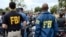 FILE - FBI agents look on as the gay pride parade kicks off in West Hollywood, Calif., June 12, 2016. 