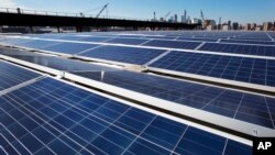 FILE - A rooftop is covered with solar panels at the Brooklyn Navy Yard in New York, Feb. 14, 2017.