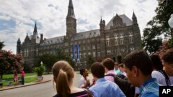 FILE - In this July 10, 2013, file photo, prospective students tour Georgetown University's campus in Washington., DC. (AP Photo/Jacquelyn Martin, File)