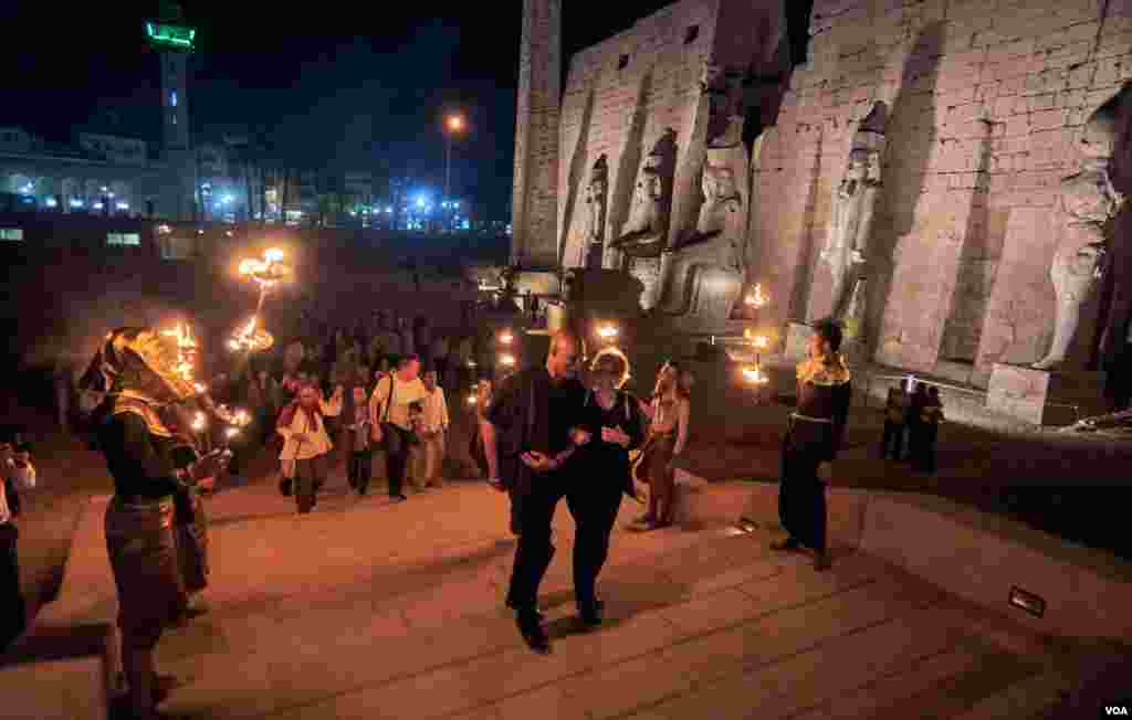 Capping a day of drama and discovery, special guests walk past archeological treasures on their way to a special dinner offered by Egyptian officials. (Photo: H. Elrasam)