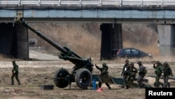 FILE - South Korean soldiers of an artillery unit take part in an artillery drill with 155mm Towed Howitzers in a previous year's Foal Eagle joint military exercise of the U.S. and South Korea, near the demilitarized zone (DMZ). In the wake of North Korea’s recent nuclear test and long-range rocket launch, Washington and Seoul will focus in part on defending against attacks by weapons of mass destruction during this year’s annual joint exercises.