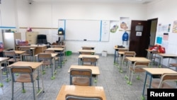 FILE - An empty classroom is seen in a private school in Hawally, after the Ministry of Education suspended schools and universities due to the coronavirus outbreak, in Kuwait City, Kuwait, March 2, 2020.