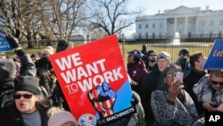 FILE - Union members and other federal employees stop in front of the White House in Washington during a rally to call for an end to the partial government shutdown, Jan. 10, 2019.