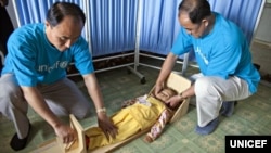 FILE - UNICEF staff measure a girl's height to see if she is stunted in a village health clinic of South Hamgyong province, North Korea.