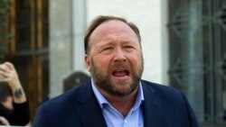 FILE--Alex Jones speaks to reporters in Washington, Sept. 5, 2018.
