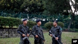 FILE - Police officers stand guard outside a Shah Alam court house at Shah Alam outside Kuala Lumpur, Malaysia on Friday, July 28, 2017.