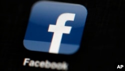 FILE - In this May 16, 2012, file photo, the Facebook logo is displayed on an iPad in Philadelphia. Facebook is under fire for failing to rein in fake and biased news stories that some believe may have swayed the presidential election. Its predicament ste