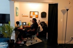 Teacher Angela McByrd works on her laptop to teach remotely from her home in Chicago, Sept. 24, 2020.