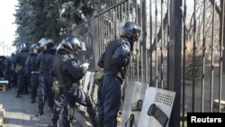 Riot police prepare for duty near the Ukrainian parliament in Kiev February 21, after Ukraine's President Viktor Yanukovich announced concessions to his pro-European opponents, including a plan to hold early elections.