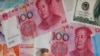 FILE - A man walks by a money exchange shop decorated with Chinese yuan in Hong Kong, Aug. 6, 2019.