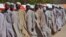 Men who were being detained on suspicion of affiliation to Boko Haram, line up as they are released by the Nigerian military in Maiduguri, Nigeria, July 6, 2015
