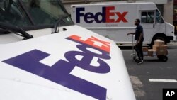 FILE - FedEx trucks are seen parked in New York, Aug. 22, 2017. Companies with ties to the National Rifle Association have been dealing with increasing public pressure since the Parkland, Florida, shooting that killed 17 people earlier this month to sever