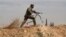 FILE - A Shi'ite fighter clashes with members of the Sunni-dominated Free Syrian Army rebel in the town of Hatita, in the countryside of Damascus, Syria, Nov. 22, 2013.