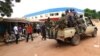 FILE - Militias of the Seleka alliance drive past stalls at the central market in Bangui, Central African Republic, in March, 2013.