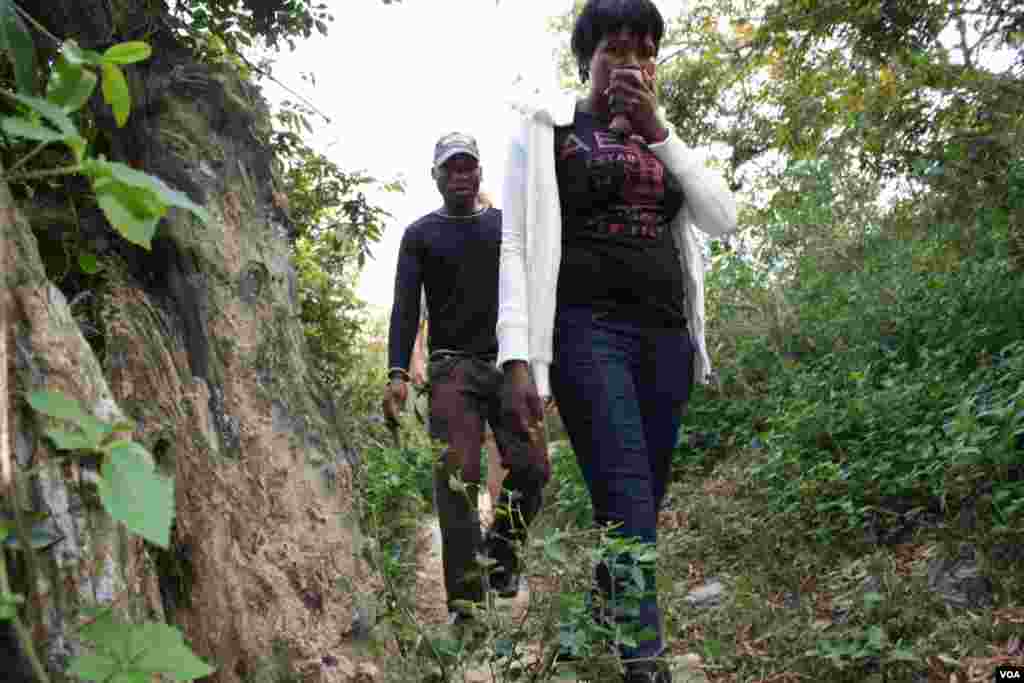 The party of ill people must negotiate rough terrain, including a forest, to get to healthcare. (VOA/D. Taylor)