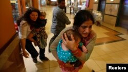 지난해 9월 케냐 나이로비 소재 웨스트게이트 쇼핑몰 총격 사건 발생 당시 어린아이를 안고 안전한 곳으로 대피하는 여성들의 모습. 알샤바브가 일으킨 이 사건으로 67명이 사망했다.