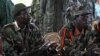 FILE - The leader of the Lord's Resistance Army, Joseph Kony, left, and his deputy, Vincent Otti, are seen sitting inside a tent in Ri-Kwamba, southern Sudan, Nov. 12, 2006.