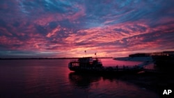 FILE - In this Sept. 2, 2015, photo, a ferry anchors at the Mekong river bank before transporting villagers from Phnom Penh, Cambodia. When Western governments began pouring money into the Mekong River Commission, they hoped it would help four Southeast Asian countries cooperate in responsibly managing one of the world’s great rivers. Two decades later, they have a surfeit of disregarded reports to show for the $320 million they spent, and a cascade of hydro power developments that benefit the narrow interests of dam builders but are ravaging the river basin, a crucial source of rice, fish and livelihoods for 60 million people. (AP Photo/Heng Sinith, File)