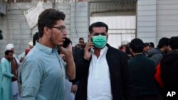 파키스탄 버스 사고로 숨진 희생자 유가족이 전화 통화를 하고 있다. (AP)