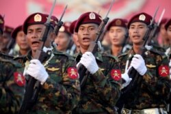 FILE - Soldiers take part in a military parade to mark Armed Forces Day, in the capital Naypyitaw, Myanmar, March 27, 2019.