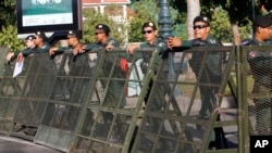 Riot police stand guard at a blocked street outside the Supreme Court in Phnom Penh, Cambodia, Nov. 16, 2017.