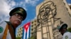 FILE - Members of a military band stand under the iron sculpture of Ernesto "Che" Guevara at Revolution Square in Havana, Cuba