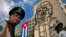 FILE - Members of a military band stand under the iron sculpture of Ernesto "Che" Guevara at Revolution Square in Havana, Cuba