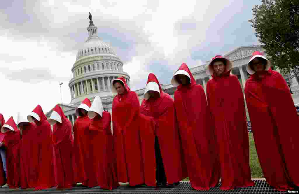 Women dressed as handmaids from the novel, film and television series "The Handmaid's Tale" demonstrate against cuts for Planned Parenthood in the Republican U.S. Senate healthcare bill at the Capitol in Washington, D.C.