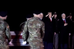 FILE - U.S. President Donald Trump and Vice President Mike Pence attend a dignified transfer of the remains of U.S. Special Forces soldier Sgt. 1st Class Javier Gutierrez who was killed in an attack in Afghanistan.