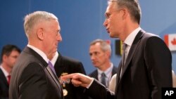 U.S. Defense Secretary Jim Mattis, left, speaks with NATO Secretary General Jens Stoltenberg during a meeting of NATO defense ministers at NATO headquarters in Brussels, June 29, 2017.