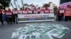 Fake bank notes showing images of U.S. President Donald Trump are displayed as protesters stage a rally to oppose the United States' demand for raising the defense costs for stationing U.S. troops in South Korea, near the U.S. embassy in Seoul,…