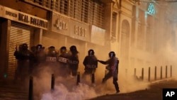 Police block demonstrators from reaching the government palace during a protest against President Evo Morales' reelection, in La Paz, Bolivia, Nov. 6, 2019. 