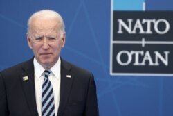 U.S. President Joe Biden arrives to be greeted and pose for a photograph with NATO Secretary General Jens Stoltenberg during the NATO summit at the North Atlantic Treaty Organization's headquarters, in Brussels, June 14, 2021.