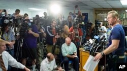 Kevin Stricklin (R), an administrator with Mine Safety and Health Administration, speaks during a press conference near Upper Big Branch coal mine in Montcoal, West Virginia, 08 Apr 2010, three days after an explosion killed 25 miners