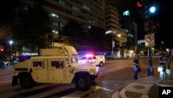 A Humvee blocks an intersection along K Street in downtown Washington as demonstrators protest the death of George Floyd, June 1, 2020, in Washington. 