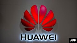 FILE - In this July 4, 2018, photo, the Huawei logo is seen at a Huawei store at a shopping mall in Beijing. 