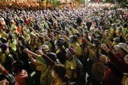 Demonstrators raise their fists during a Black Lives Matter protest at the Mark O. Hatfield United States Courthouse, July 23, 2020, in Portland, Ore.