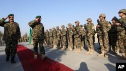 FILE - General Sher Mohammad Karimi, chief of staff of the Afghan army, second left, salutes soldiers during a ceremony in Laghman province, east of Kabul, Afghanistan, Jan. 11, 2015.