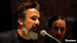 FILE - Manuel Oliver, father of Joaquin Oliver, one of 17 people killed in the 2018 shootings at Marjory Stoneman Douglas High School in Parkland, Fla., speaks at a press conference on the one-year anniversary of the attack, in New York, Feb. 14, 2019.