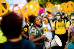 FILE - Black Lives Matter organizer Teal Lindseth, 21, leads protesters in Portland, Ore.