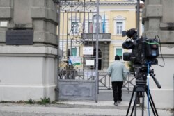 A man passes through the main gate of the Lazzaro Spallanzani hospital, the National Institute for Infectious Diseases, in Rome, Jan. 31, 2020.