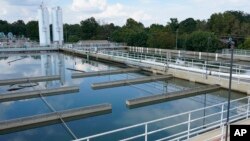 FILE - Clouds are reflected off the City of Jackson's O.B. Curtis Water Treatment Facility's sedimentation basins in Ridgeland, Mississippi, Sept. 2, 2022.