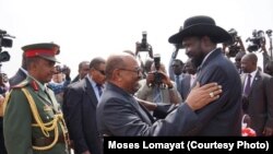 South Sudanese President Salva Kiir (r.) hugs his Sudanese counterpart Omar al Bashir on his arrival at Juba airport on Friday, April 12, 2013. The Sudanese president was visiting South Sudan for the first time since it split from Sudan in 2011.