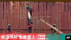 រូបឯកសារ៖ កម្មករ ធ្វើការ​នៅ​ការដ្ឋាន​សំណង់​រោងចក្រ​ផលិត​សំបក​កង់​រថយន្ត​របស់​ចិន​ដំបូង​គេ​នៅ​អឺរ៉ុប នៅ​ក្បែរ​ក្រុង Zrenjanin ភាគ​ខាងជើង​ប្រទេស​ស៊ែប៊ី​ដែល​ស្ថិត​នៅ​ចម្ងាយ​ប្រមាណ​៥០គីឡូម៉ែត្រ ពី​ទីក្រុង​ប៊ែលក្រាដ ប្រទេស​ស៊ែប៊ី កាលពី​ថ្ងៃទី១៨ ខែវិច្ឆិកា ឆ្នាំ២០២១។